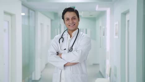 Portrait-of-Happy-Indian-doctor-standing-crossed-hands