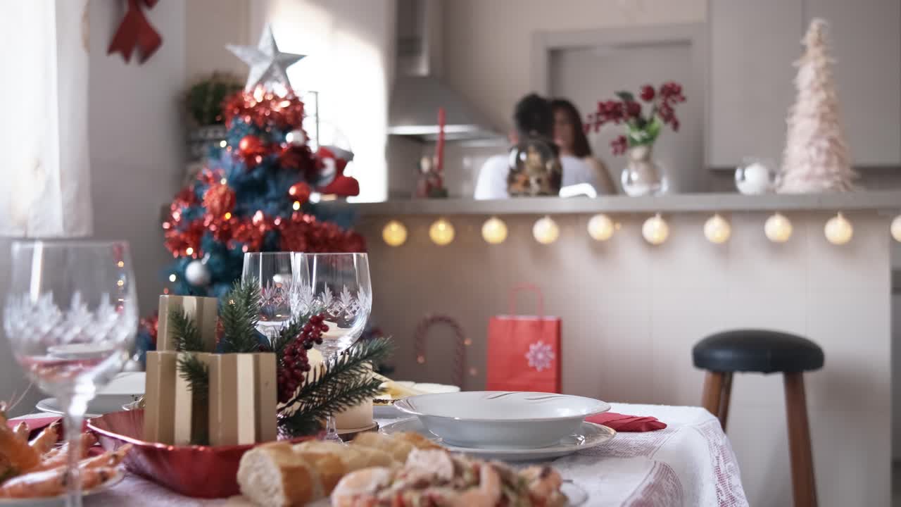Christmas decorations on the table while a girl sets the table to eat