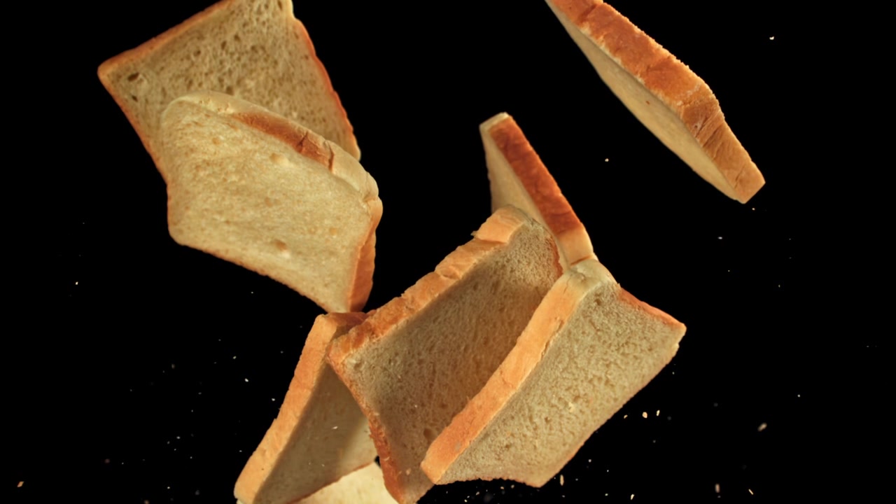 Slow Motion of Bread Slices Falling on Black Background