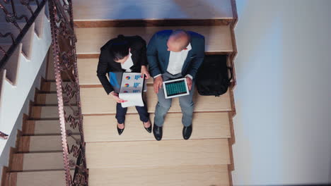 top view of furious overworked businesswoman explaining graphs