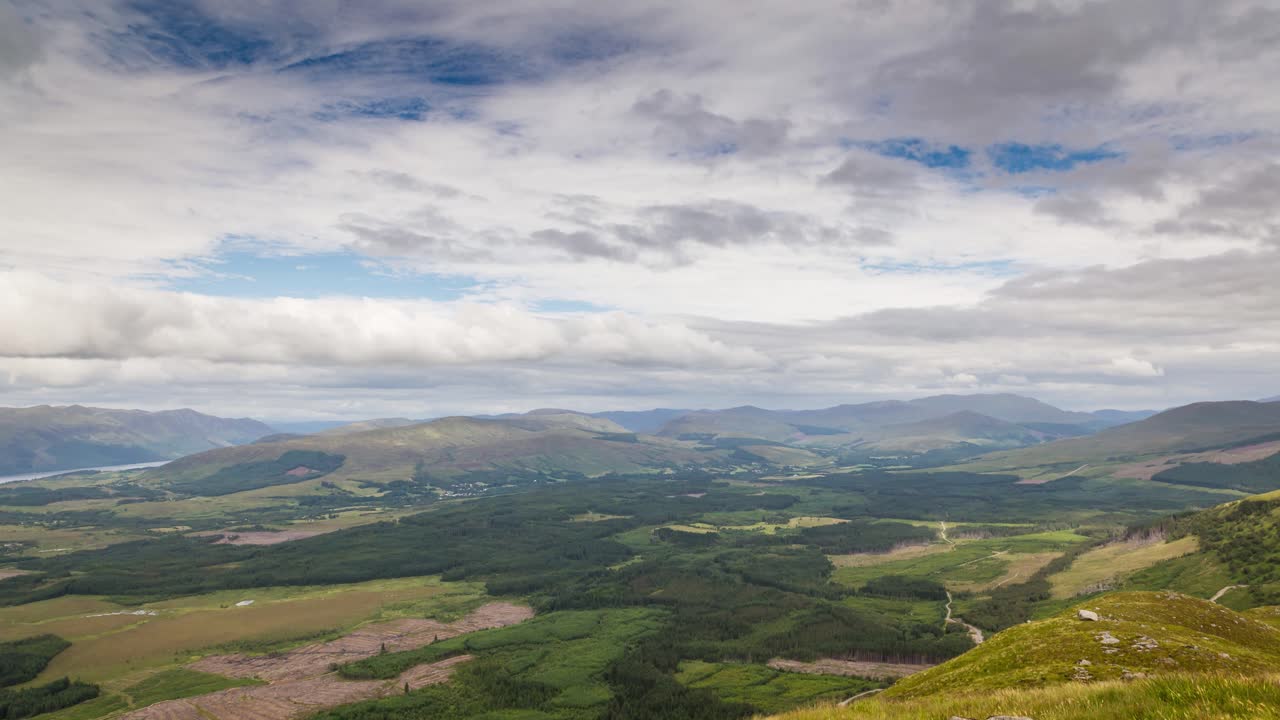Timelapse of view from Ben Nevis mountain in Scotland, looking over fields with clouds