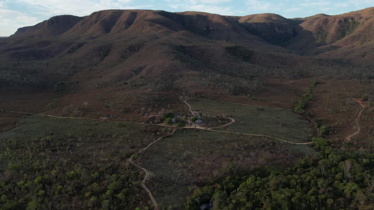 aerial view village in Chapada dos Veadeiros &amp;quot;Aldeia Macaco&amp;quot; hollow-shaped bioconstruction houses cerrado landscape Goi&aacute;s Brazil