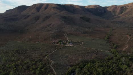 aerial-view-village-in-Chapada-dos-Veadeiros-"Aldeia-Macaco"-hollow-shaped-bioconstruction-houses-cerrado-landscape-Goiás-Brazil