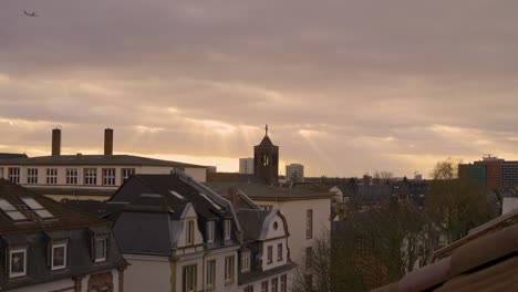 golden hour light over frankfurt, with a church tower and distant buildings