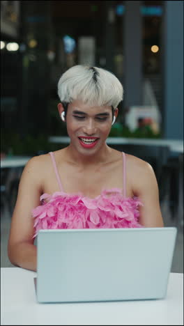 person using a laptop in an outdoor cafe