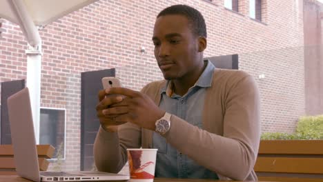 Sitting-young-man-using-smartphone