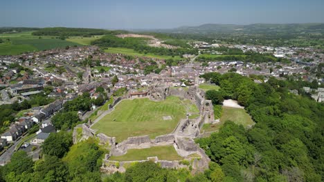 Denbigh-Castle-and-Town-Walls,-Denbighshire,-Wales---Aerial-drone-anti-clockwise-distant-pan-from-rear-to-side---June-23