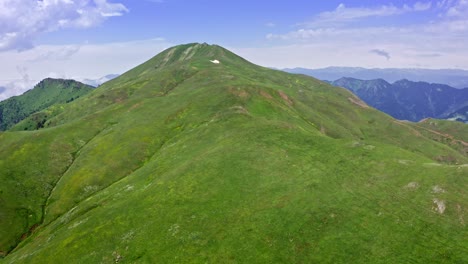 Aerial-View-Of-Green-Hill-On-Top-Of-Mountain