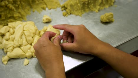 making bakpia pathok, hands preparing the traditional javanese sweet pastry