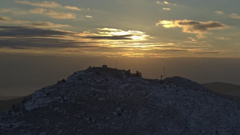 aerial - sunset with clouds behind a snowy mountain - shot on dji inspire 2 x7 50mm raw