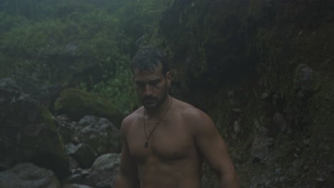 a man with a beard and wet hair is captured in a natural, candid moment walking on the quebrada gata trail