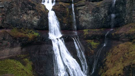 aerial: crane shot ascending up rjukandafoss waterfall, a hidden treasure amidst iceland's pristine wilderness