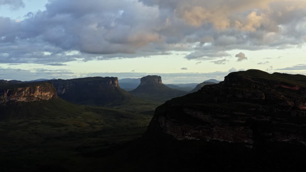 Trucking left flying drone landscape shot of the stunning Capao Valley from the Mount of Pai Inácio in the Chapada Diamantina national park in northern Brazil on a warm sunny golden hour evening