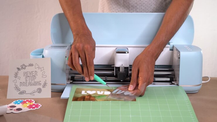 Hands carefully crafting vinyl in a design studio setting