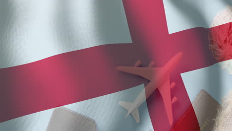 airplane flying over england flag animation with travel-related items in background