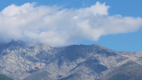 filmed with a drone in slow motion filmed in 167mm of the central massif of gredos on its southern slope, we see its peaks and the clouds are retained creating shadows and there is a beautiful sky.