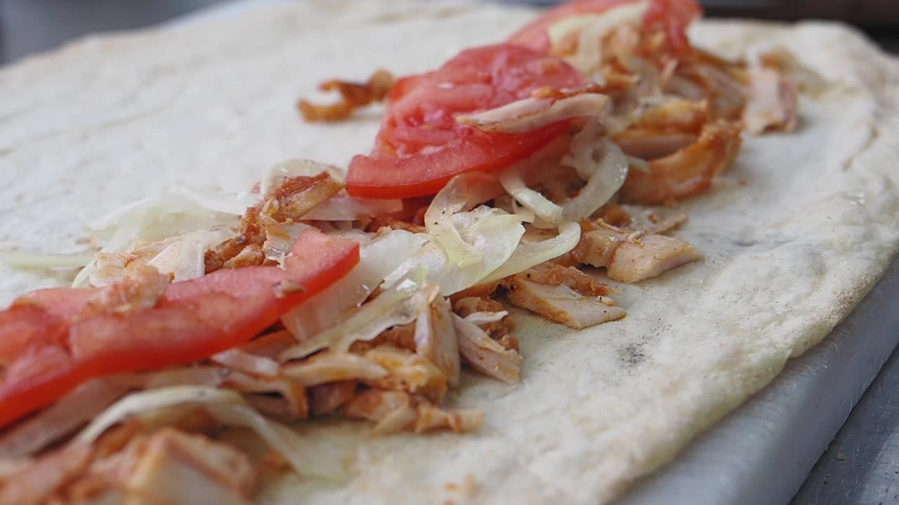 Shawarma wrap with chicken, tomato, and onion