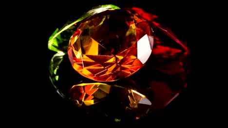 rotating gemstones with reflection on black background