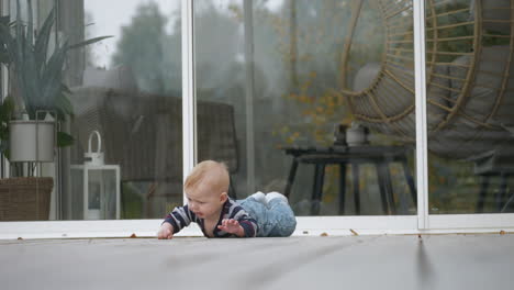 helpless caucasian baby toddler falling in the backyard, slow motion