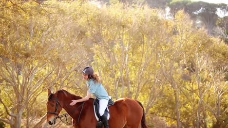 pretty smiling woman riding horse