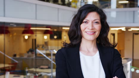 businesswoman walking into focus in an office