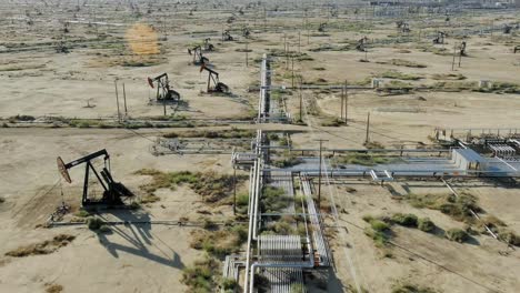 Aerial-of-pumpjacks-in-a-fracking-field-drilling-for-oil,-concept-of-climate-crisis