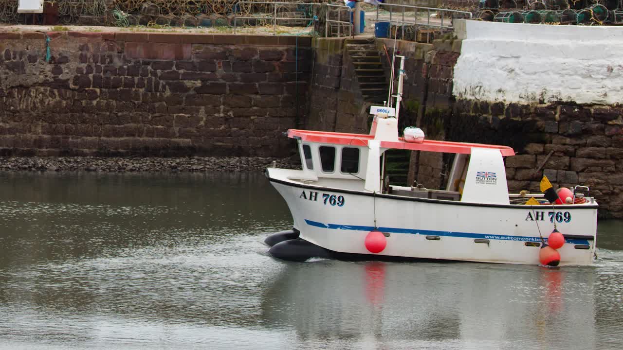 Small fishing boat moves through calm harbor waters, overcast daylight, steady camera, tranquil mood