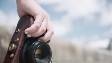 Someone-walking-down-the-road-with-a-camera-in-their-hand