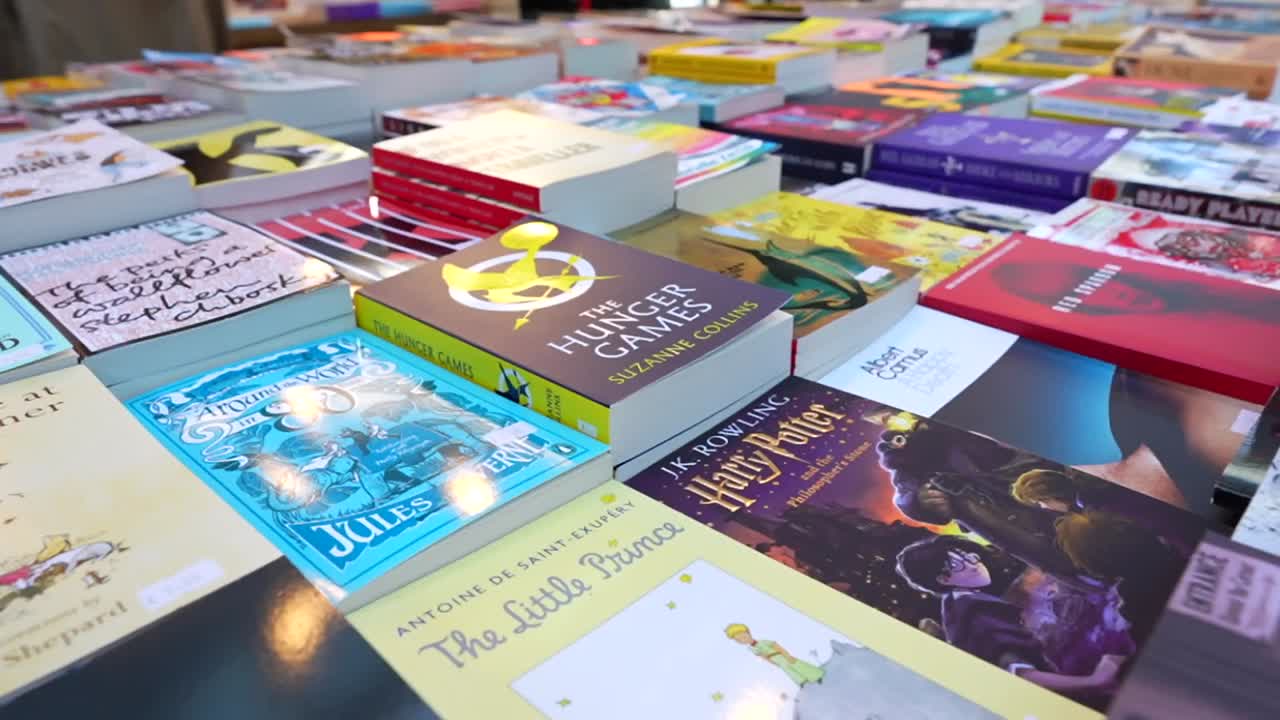 Colorful book display at a market showcasing popular novels and literary classics