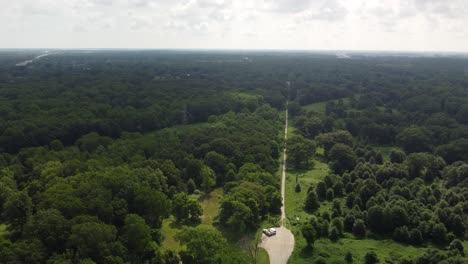 4k drone overhead of symmetrical road through obijway park forest, windsor ontario