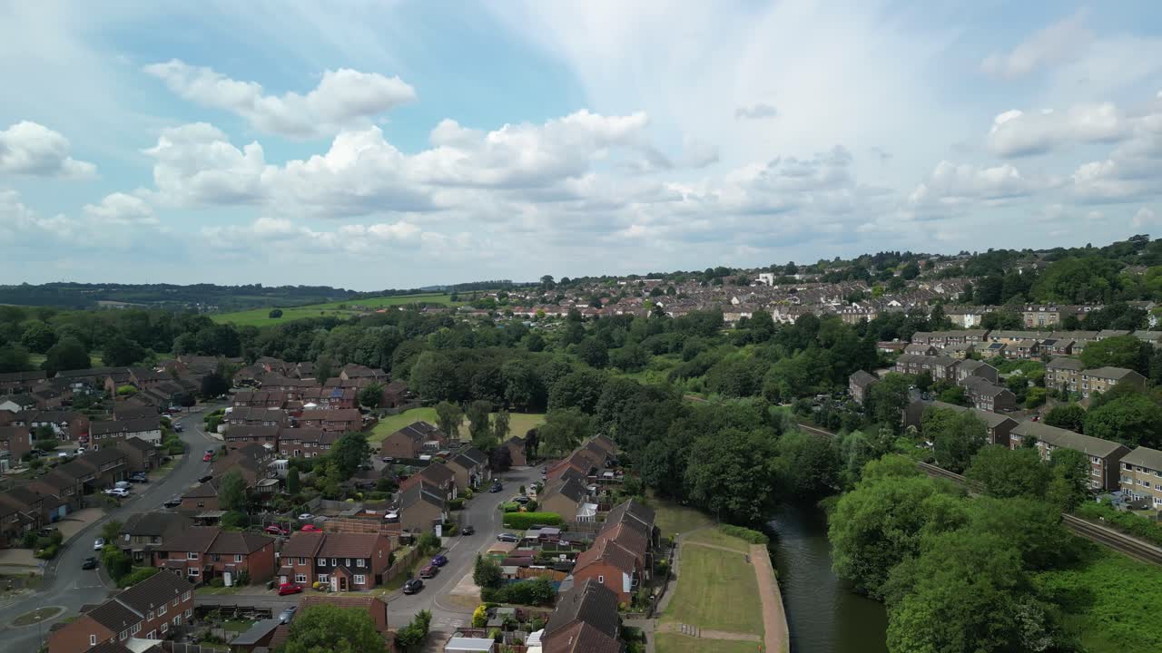 Wide drone shot over Maidstone rooftops and treelined streets on a clear day in Kent