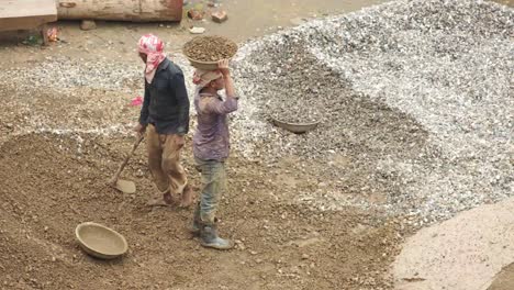 construction workers handling gravel