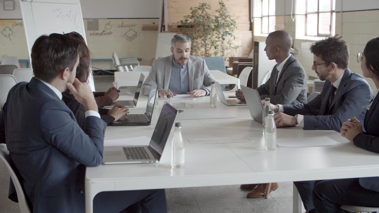 Confident boss talking to subordinates