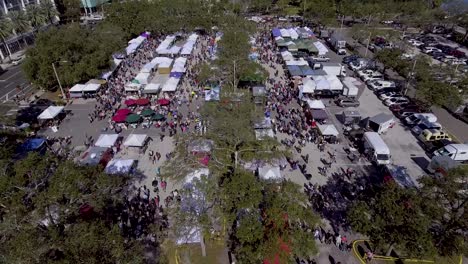 4k aerial drone video of shoppers at farmers market in downotwn st