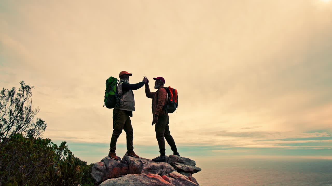 Two hikers meeting on a mountaintop