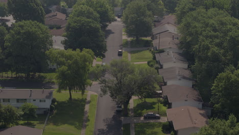 Slow flyover push down suburban street and ranch style rooftops