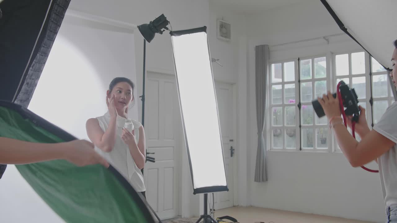 Behind The Scenes On Photo Shoot: Beautiful Asian Model Poses For A Photographer, She Takes Photos With Professional Camera