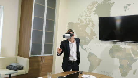 Man With Glasses Of Virtual Reality. Smiling man in the office having the VR experince