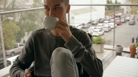 man using mobile phone while having coffee at home 4k