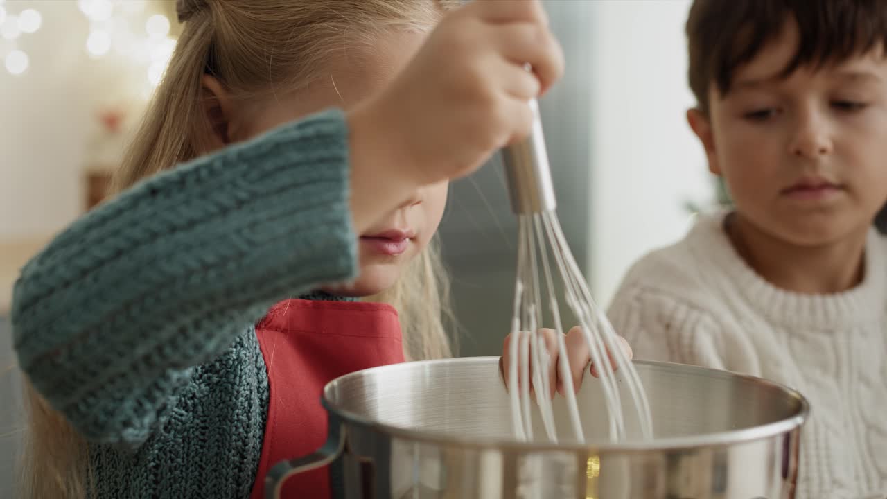 Video of girl mixing and tasting sugar paste during baking