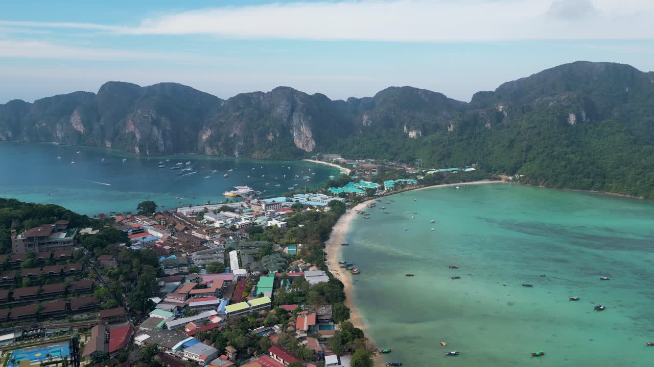 Aerial view of Phi Phi Don’s twin bays, turquoise waters, and vibrant coastal town in Thailand