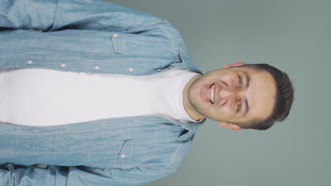 Vertical-video-of-Man-smiling-at-camera