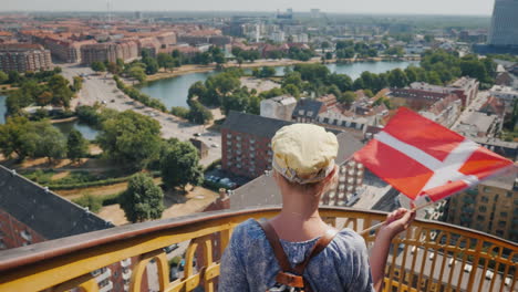 a woman descends from the tower through the ancient spiral staircase against the background of the c