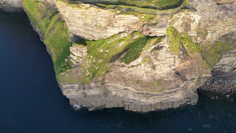 drone shot panning down the cliffs of moher at sunset