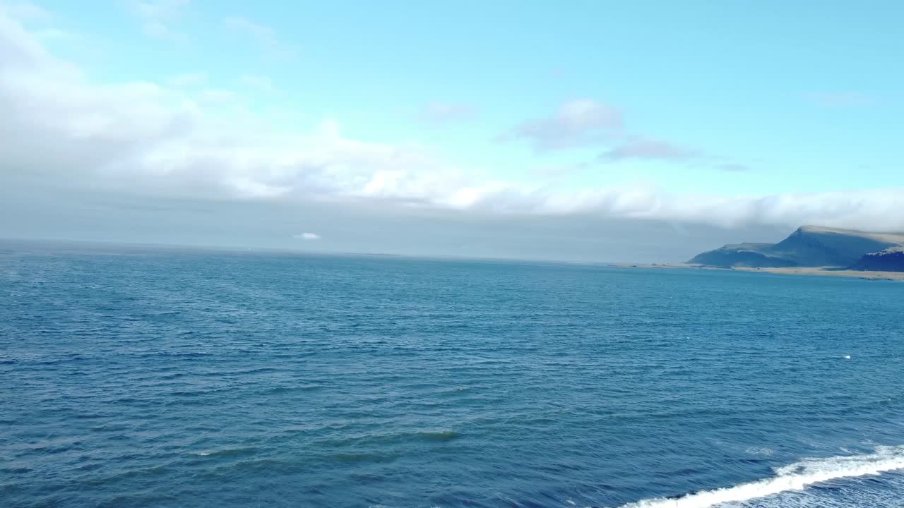 Stunning aerial footage of Iceland's rugged terrain, featuring majestic mountains and serene waters under a vibrant sky. Captures the raw beauty and tranquility from above