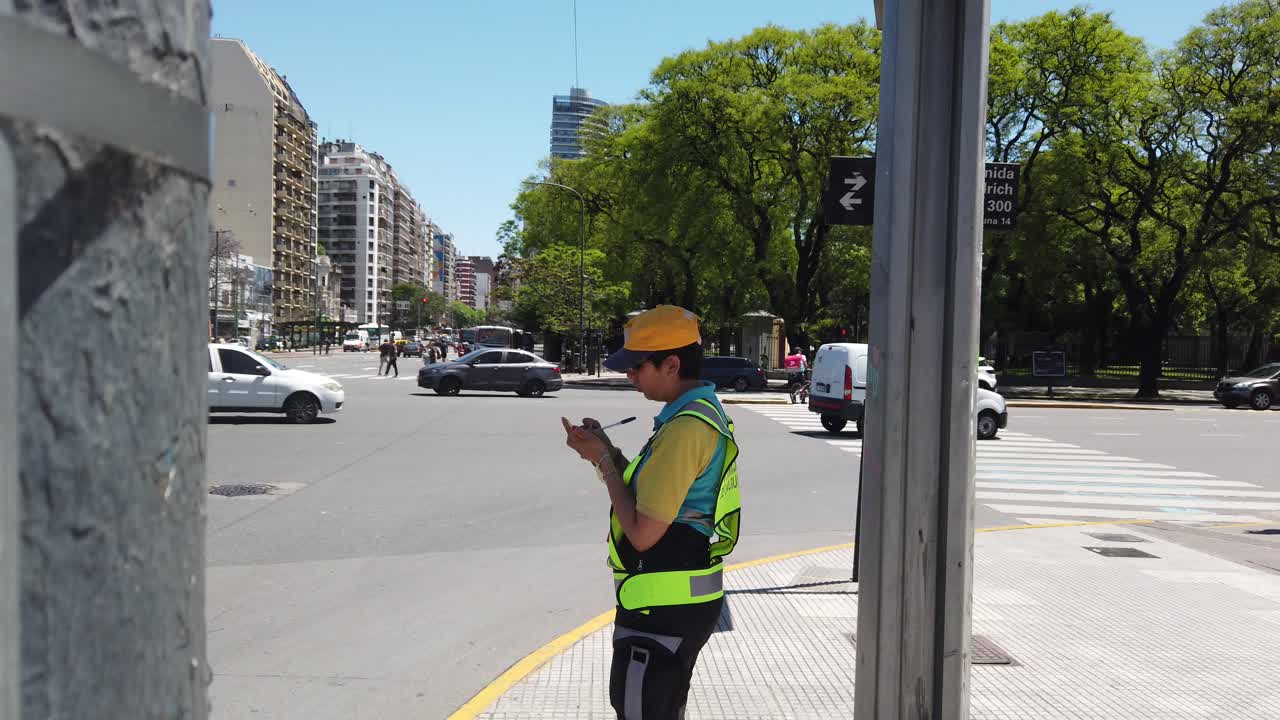 Traffic police officer makes a fine in residential downtown busy avenue Panning view
