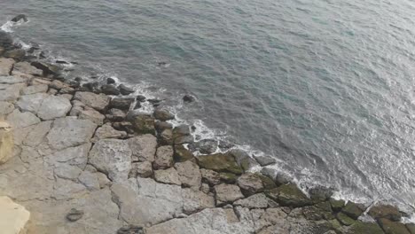 aerial view along rocky coast in jiwani with waves breaking gently in balochistan