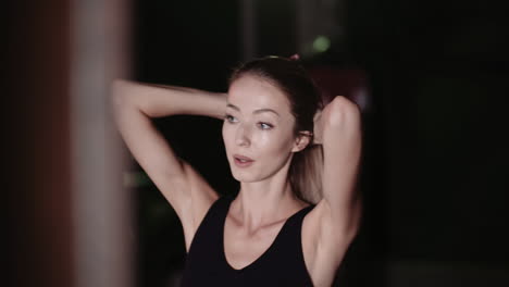 Slow-Motion-Of-Attractive-Female-Athlete-Tying-Hair-Before-Workout-At-Gym