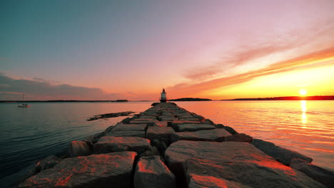 Sunrise-at-Spring-Point-Ledge-Lighthouse-with-serene-sky,-showcasing-beautiful-orange-and-yellow-clouds