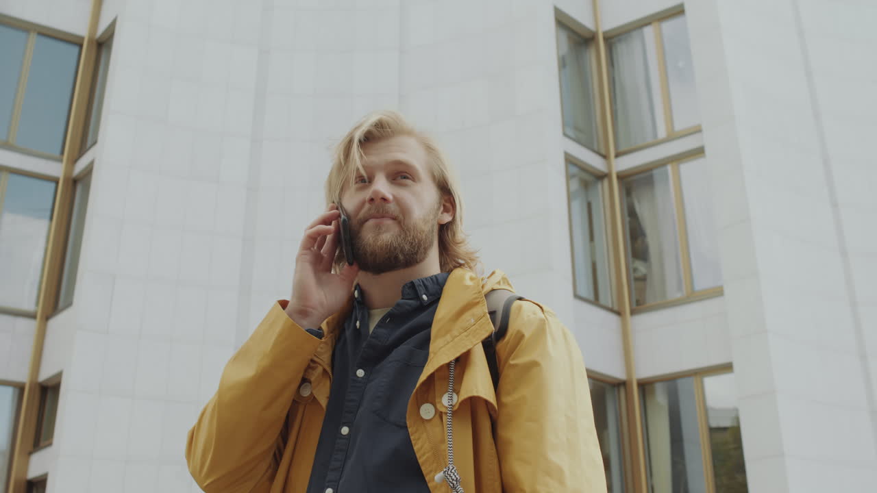 Man Speaking on Mobile Phone Outdoors